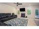 Cozy Gathering room with fireplace, large TV, and comfortable seating, bathed in natural light from the windows at 856 Donington Cir, Lawrenceville, GA 30045