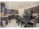 Eat-in kitchen features stainless steel appliances, dark cabinetry, and a tiled backsplash at 856 Donington Cir, Lawrenceville, GA 30045