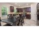 Bright kitchen with stainless steel appliances, dark wood cabinets, and a large dining area at 856 Donington Cir, Lawrenceville, GA 30045