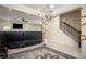 Spacious living room with elegant chandelier, opening into a cozy Gathering room, staircase, and natural light at 856 Donington Cir, Lawrenceville, GA 30045