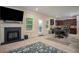 Open-concept living space featuring a Gathering room with fireplace, dining area, and modern kitchen with dark cabinetry at 856 Donington Cir, Lawrenceville, GA 30045