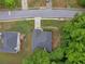 A bird's eye view shows the house's roof, lawn and driveway, framed by mature trees at 361 Brackin Trce, Grayson, GA 30017