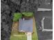An aerial view reveals a home with lush landscaping, mature trees, and a well-maintained roof at 361 Brackin Trce, Grayson, GA 30017