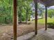 Back yard with a covered patio, green grass and lots of trees at 361 Brackin Trce, Grayson, GA 30017