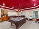 Spacious basement with red ceiling, pool table, leather sofa and storage cabinet at 361 Brackin Trce, Grayson, GA 30017