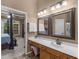Large bathroom with dual sinks, framed mirrors and doorway to the bedroom at 361 Brackin Trce, Grayson, GA 30017