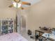 Bedroom featuring a ceiling fan, doorway to the hallway, and storage shelves at 361 Brackin Trce, Grayson, GA 30017