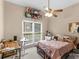 Neutral bedroom with a twin bed, ceiling fan and a window offering backyard views at 361 Brackin Trce, Grayson, GA 30017