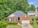 Charming brick home with a two-car garage, neat landscaping, and a walkway to the front door at 361 Brackin Trce, Grayson, GA 30017