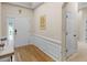 Foyer featuring light wood flooring, decorative trim, a white front door, and an adjacent closet door at 361 Brackin Trce, Grayson, GA 30017