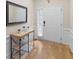 Entryway features a light wood floor, white trim, and a console table beneath a decorative mirror at 361 Brackin Trce, Grayson, GA 30017