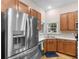 Modern kitchen with stainless steel refrigerator, window above sink, and ample cabinets at 361 Brackin Trce, Grayson, GA 30017