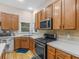 Well-equipped kitchen with stainless steel appliances, a gas range, and plenty of counter space at 361 Brackin Trce, Grayson, GA 30017