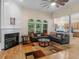 Spacious living room with a fireplace, hardwood floors, arched windows and decorative furniture at 361 Brackin Trce, Grayson, GA 30017