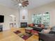 Inviting living room with a fireplace, hardwood floors, arched windows, and comfortable furniture at 361 Brackin Trce, Grayson, GA 30017