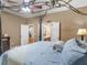 Spacious bedroom with ceiling fan and four poster bed, featuring a doorway to the en-suite bathroom at 361 Brackin Trce, Grayson, GA 30017