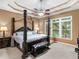 Elegant main bedroom featuring a canopy bed, tray ceiling, and large windows at 361 Brackin Trce, Grayson, GA 30017