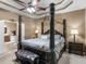 Luxurious main bedroom with a canopy bed, ensuite bathroom, and stylish decor at 361 Brackin Trce, Grayson, GA 30017