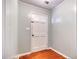 Entryway featuring light-colored paneling, a white door with glass panes, and hardwood flooring at 428 Cornish Mountain Rd, Oxford, GA 30054