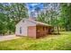 Back view of the brick house with a red metal roof and a lawn at 428 Cornish Mountain Rd, Oxford, GA 30054