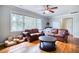 Cozy living room featuring hardwood floors, a ceiling fan, and comfortable leather seating at 428 Cornish Mountain Rd, Oxford, GA 30054