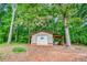 Outbuilding featuring a garage door and a porch next to the wooded lot at 428 Cornish Mountain Rd, Oxford, GA 30054