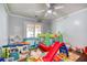 Playroom features wood floors, a ceiling fan, and access to backyard at 428 Cornish Mountain Rd, Oxford, GA 30054