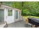 Cozy back deck with grill, perfect for outdoor entertaining amidst a lush green backdrop at 115 S Meadowcliff Cir, Carrollton, GA 30116