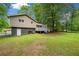 Expansive backyard with a walkout basement and deck providing ample space for recreation and relaxation at 115 S Meadowcliff Cir, Carrollton, GA 30116
