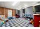 Spacious basement area with finished walls, checkered rug, and ample storage space at 115 S Meadowcliff Cir, Carrollton, GA 30116