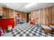 Spacious basement area with paneled walls, checkered rug, and ample storage space at 115 S Meadowcliff Cir, Carrollton, GA 30116