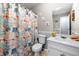 Cozy bathroom featuring vanity with sink and decorative seashell-themed shower curtain at 115 S Meadowcliff Cir, Carrollton, GA 30116