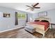 Cozy bedroom with wood floors, a large bed, side table and a window providing plenty of natural light at 115 S Meadowcliff Cir, Carrollton, GA 30116
