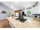 This wide angle captures the open concept kitchen with island, dining area, hardwood floors, vaulted ceilings and granite counters at 115 S Meadowcliff Cir, Carrollton, GA 30116