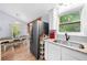 Bright kitchen with a dining area, stainless steel refrigerator, granite counters and a large window overlooking the trees at 115 S Meadowcliff Cir, Carrollton, GA 30116