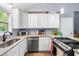 Open kitchen with a gas range, granite countertops, and an adjacent dining area at 115 S Meadowcliff Cir, Carrollton, GA 30116