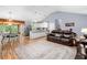 Open living space with wood floors, connecting the kitchen, dining, and living areas at 115 S Meadowcliff Cir, Carrollton, GA 30116