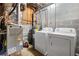 Functional utility room with washer, dryer, water heater, and HVAC system at 115 S Meadowcliff Cir, Carrollton, GA 30116