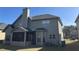 A nice backyard featuring neutral siding and a screened in porch with black screens at 1291 Long Acre Dr, Loganville, GA 30052
