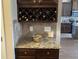 Charming bar area with granite countertops, a built-in wine rack, and tile backsplash at 1291 Long Acre Dr, Loganville, GA 30052