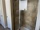Bathroom featuring a walk-in shower with glass door, neutral tiles, and a convenient layout at 1291 Long Acre Dr, Loganville, GA 30052