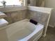 Bathroom showcasing a soaking tub with tile surround, adding a touch of luxury at 1291 Long Acre Dr, Loganville, GA 30052