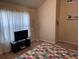 Cozy bedroom with high ceilings, a television, and a bright geometric quilt at 1291 Long Acre Dr, Loganville, GA 30052
