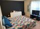 Bright bedroom with a large window and dark accent wall at 1291 Long Acre Dr, Loganville, GA 30052