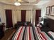 Bedroom with a king bed, gray sofa, neutral walls, and tasteful décor at 1291 Long Acre Dr, Loganville, GA 30052