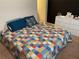 Comfortable bedroom featuring a colorful patchwork quilt at 1291 Long Acre Dr, Loganville, GA 30052