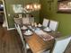 Elegant dining room featuring a wooden table, upholstered chairs, and decorative place settings at 1291 Long Acre Dr, Loganville, GA 30052