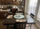 Cozy dining area features a dark wood table with seating for four, adjacent to sunlit windows at 1291 Long Acre Dr, Loganville, GA 30052