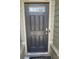 A front door with a transom window and wood detailing on the exterior of the home at 1291 Long Acre Dr, Loganville, GA 30052