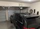 Spacious two-car garage with ample storage space featuring a black SUV at 1291 Long Acre Dr, Loganville, GA 30052